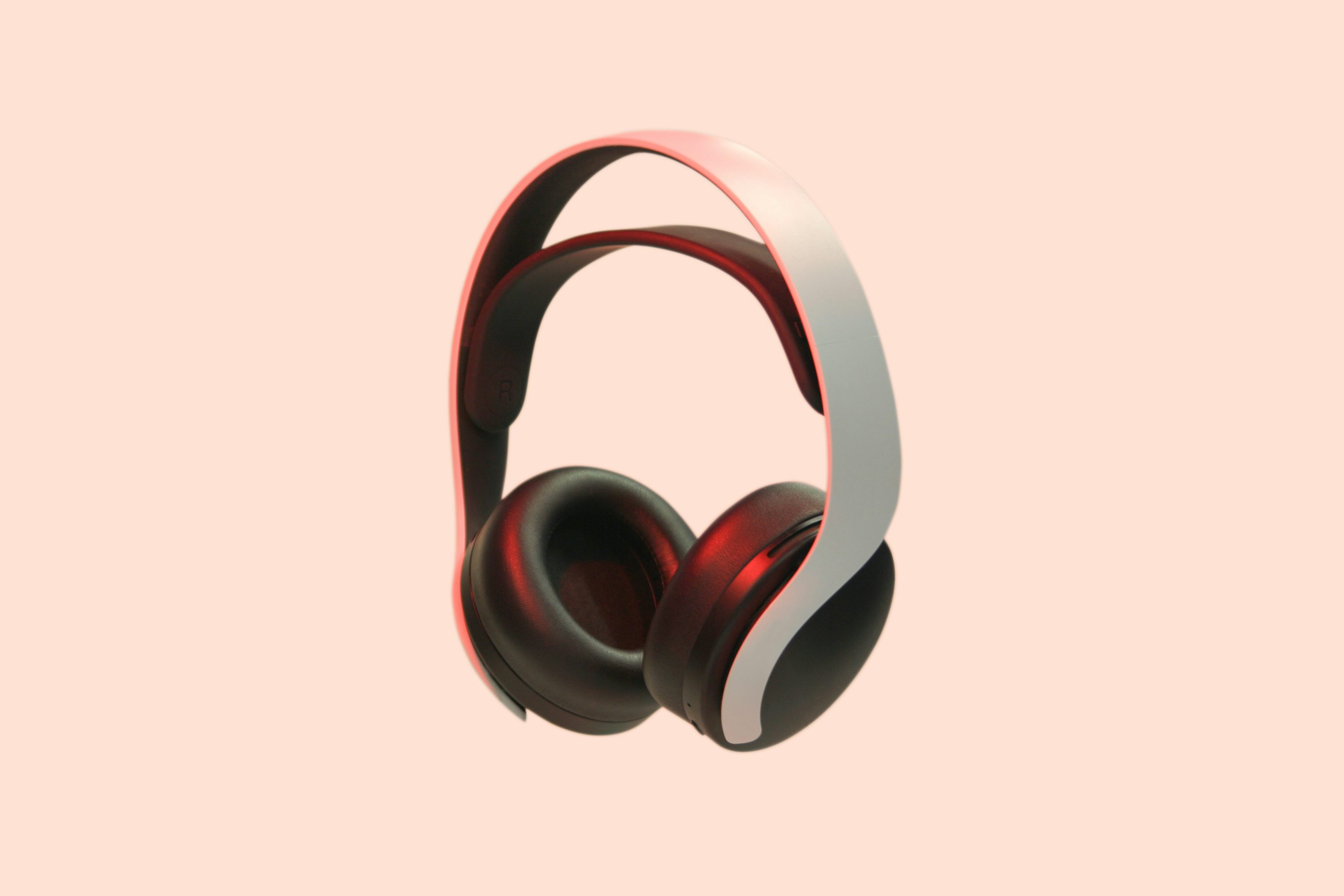 a pair of headphones with a pink background